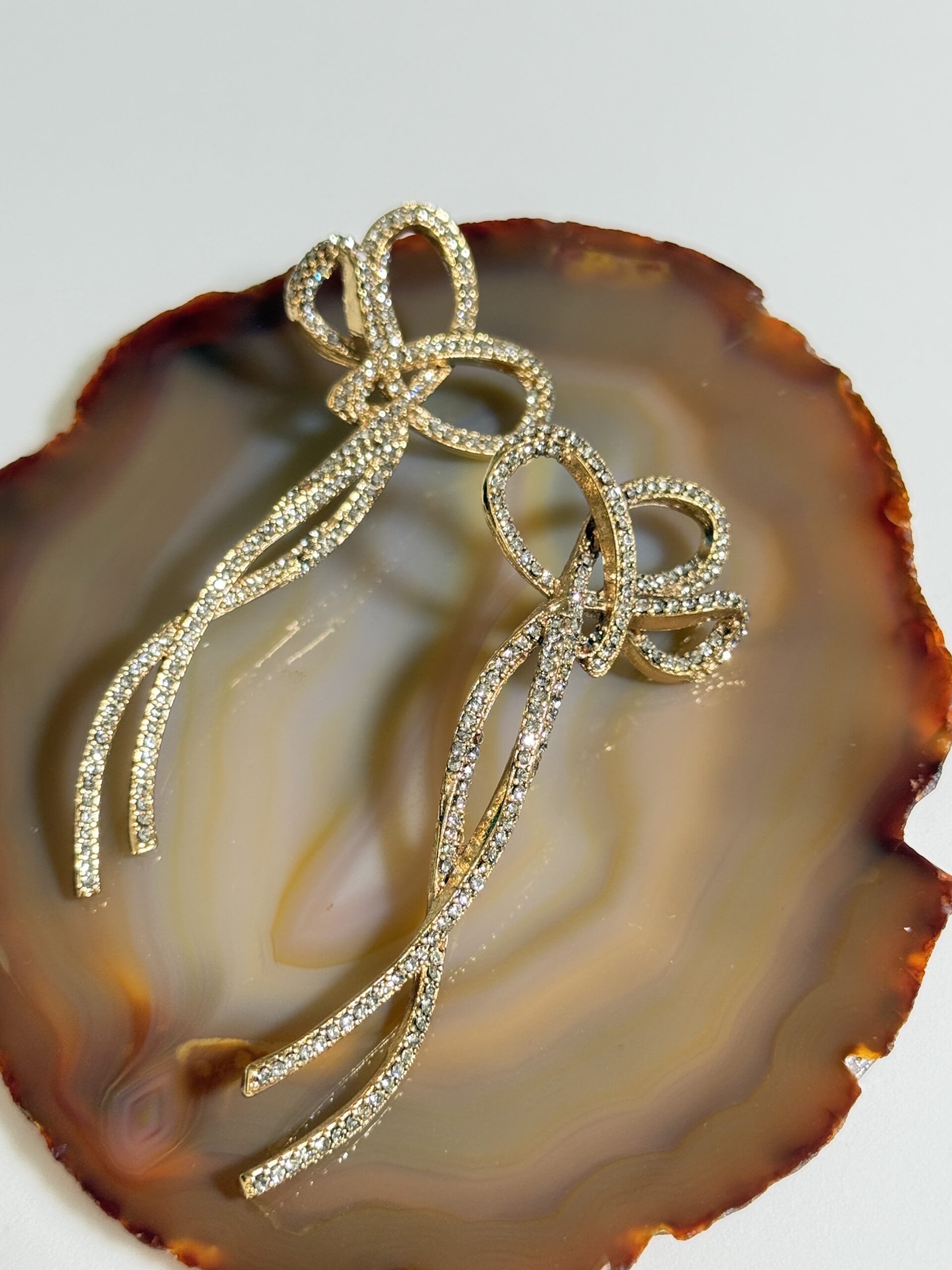 Brinco longo em laço cravejado